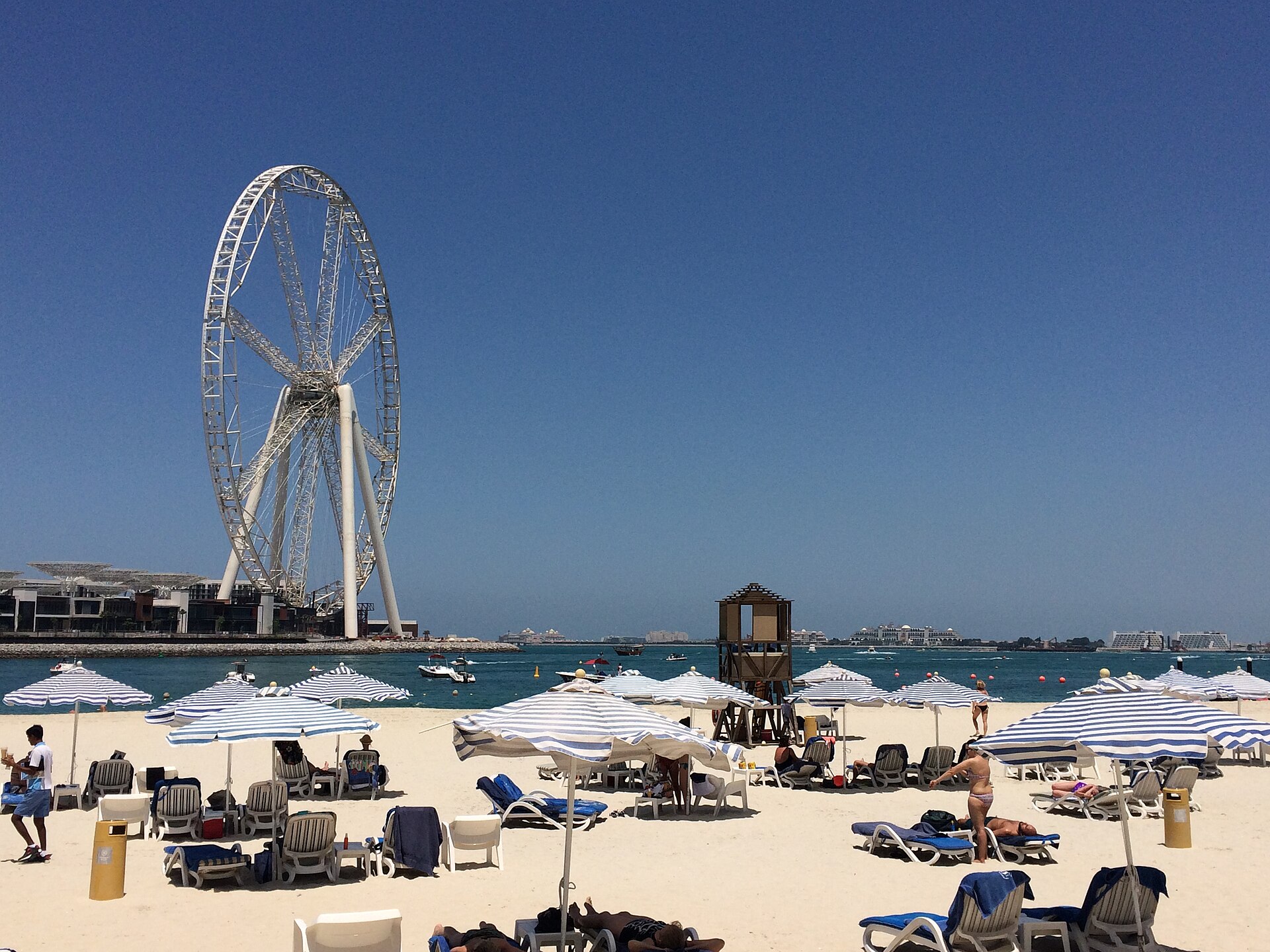 Plaża JBR w słoneczny dzień z kołem widokowym w tle